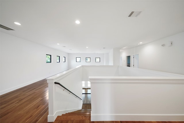 stairway with hardwood / wood-style floors