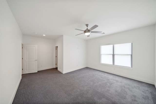 carpeted spare room featuring ceiling fan