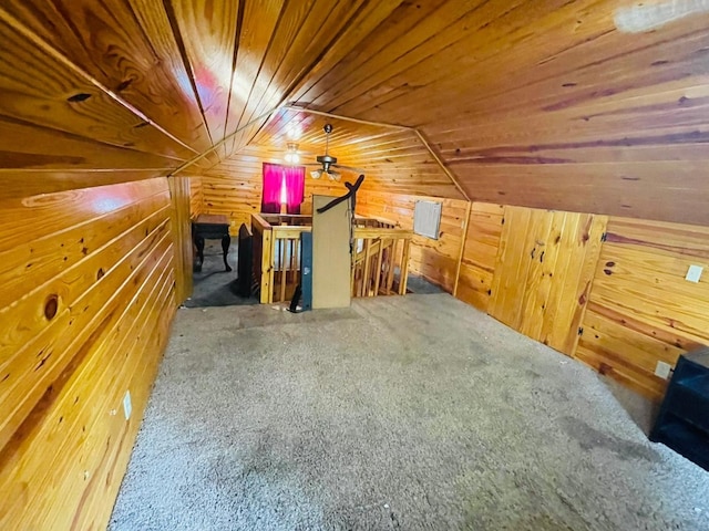 bonus room featuring vaulted ceiling, wooden ceiling, and wooden walls