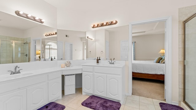 bathroom featuring vanity, a shower with shower door, and tile patterned flooring