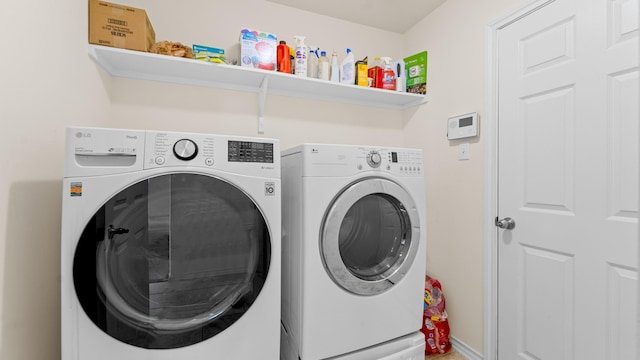 clothes washing area with separate washer and dryer