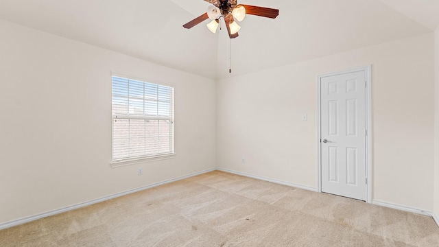 carpeted spare room with ceiling fan and lofted ceiling