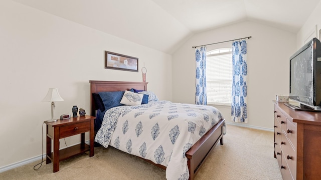 carpeted bedroom with lofted ceiling