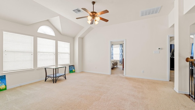 interior space with ceiling fan, lofted ceiling, and light carpet