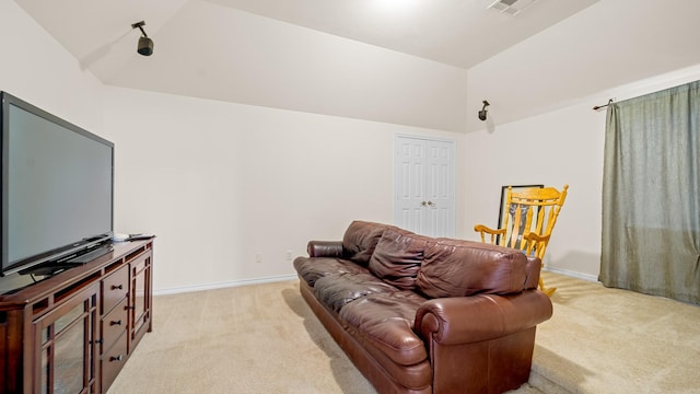 living room featuring light carpet and vaulted ceiling