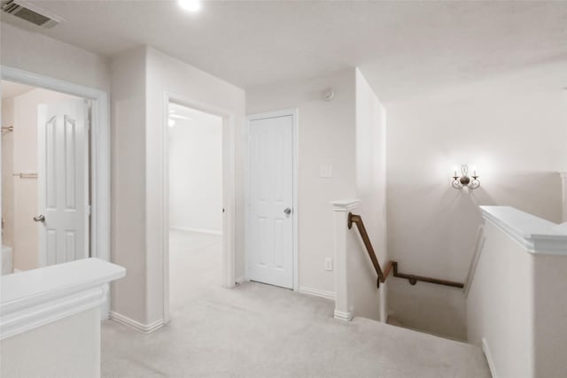 hallway with light colored carpet