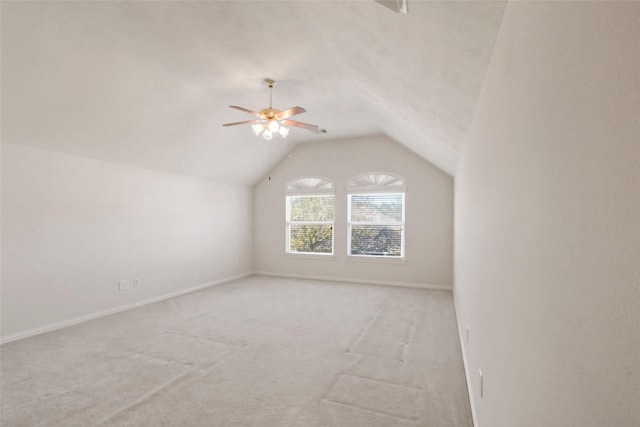 additional living space with ceiling fan, light colored carpet, and lofted ceiling