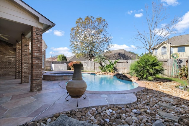 view of swimming pool with an in ground hot tub