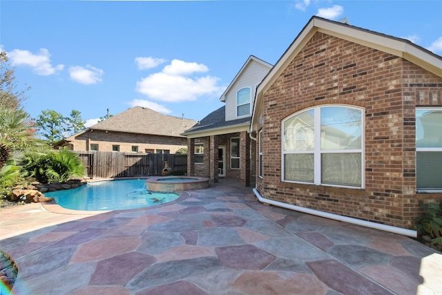 view of swimming pool featuring a patio area and an in ground hot tub