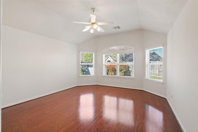 spare room featuring wood-type flooring, vaulted ceiling, ceiling fan, and a healthy amount of sunlight