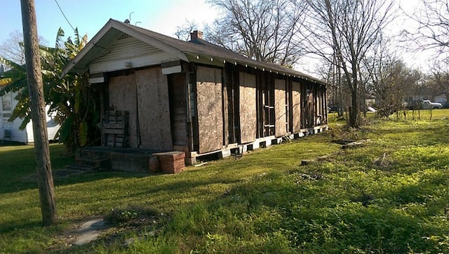 view of outdoor structure with a lawn