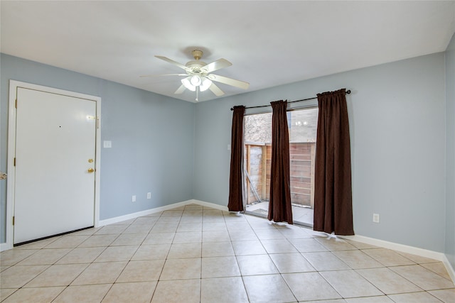 tiled empty room featuring ceiling fan