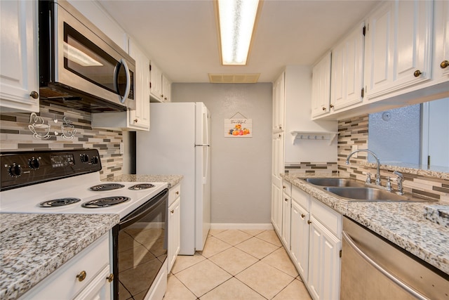 kitchen featuring sink, appliances with stainless steel finishes, tasteful backsplash, and white cabinets