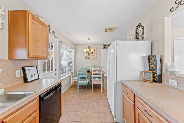 kitchen with a notable chandelier, light tile patterned floors, dishwasher, decorative light fixtures, and white refrigerator