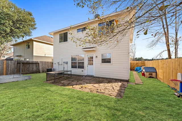 rear view of house featuring central AC unit, a lawn, and a patio area