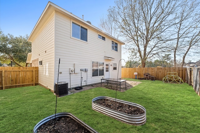 rear view of house featuring a yard, a patio, and central AC unit