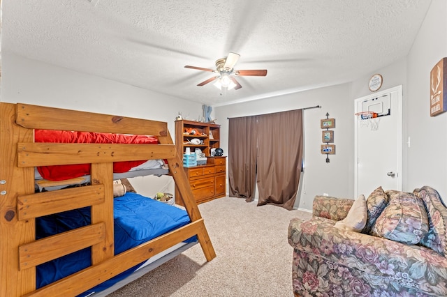 bedroom with a textured ceiling, ceiling fan, and carpet flooring