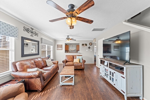 living room featuring dark wood-type flooring, a wealth of natural light, and ceiling fan