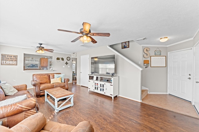 living room featuring dark hardwood / wood-style floors, ceiling fan, ornamental molding, and a textured ceiling