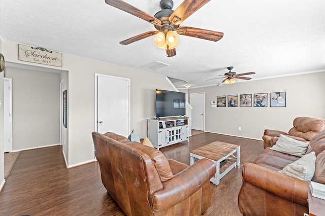 living room with dark wood-type flooring, a textured ceiling, and ceiling fan