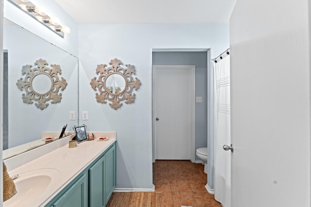 bathroom with toilet, tile patterned flooring, and double vanity