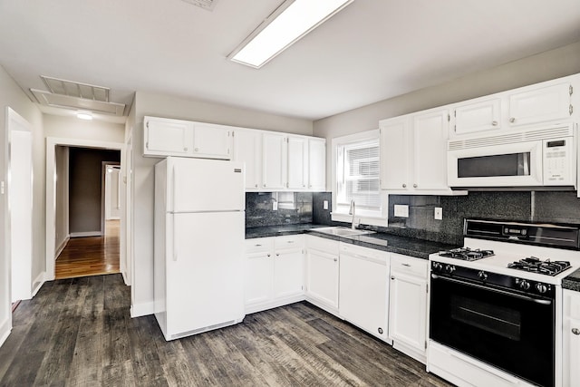 kitchen featuring sink, dark hardwood / wood-style flooring, white appliances, and backsplash