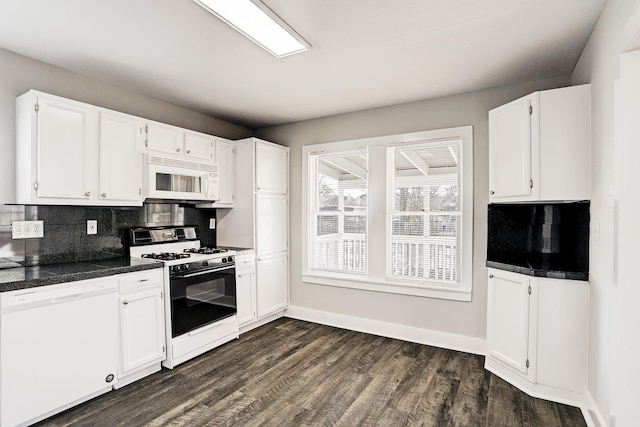 kitchen featuring dark hardwood / wood-style flooring, white cabinetry, tasteful backsplash, and white appliances