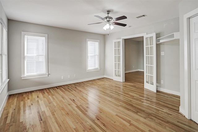 unfurnished bedroom with ceiling fan, french doors, light hardwood / wood-style flooring, and a closet