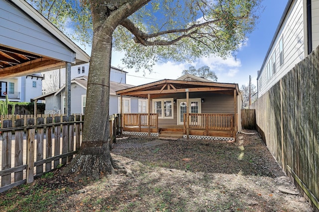 rear view of house with a wooden deck