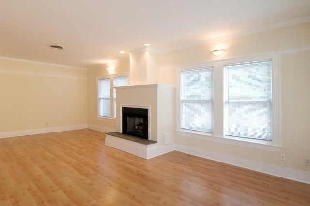 unfurnished living room featuring wood-type flooring and a wealth of natural light