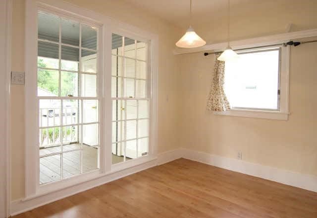 unfurnished dining area with wood-type flooring