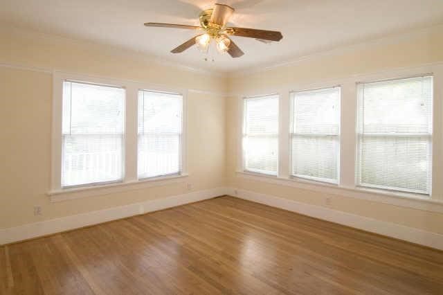 unfurnished room featuring hardwood / wood-style flooring and ceiling fan