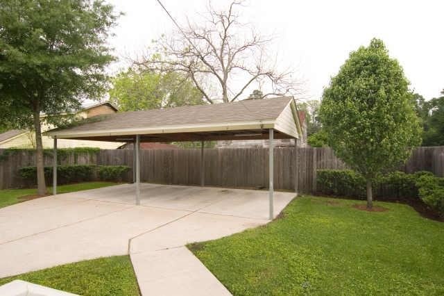 exterior space with a yard and a carport