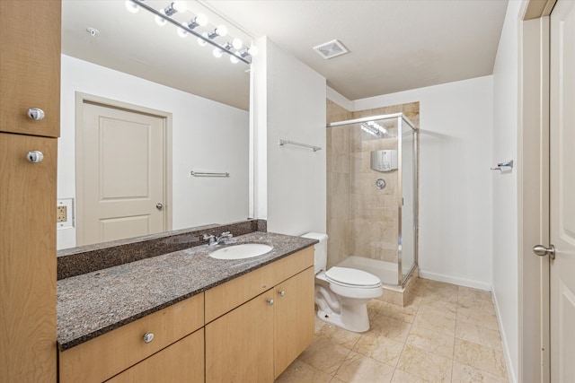 bathroom with tile patterned flooring, a shower with shower door, toilet, and vanity