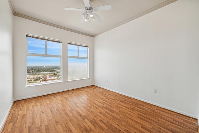 spare room featuring light wood-type flooring, ceiling fan, and ornamental molding