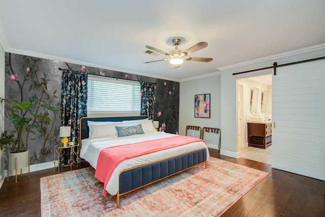 bedroom with a barn door, hardwood / wood-style flooring, crown molding, and ceiling fan