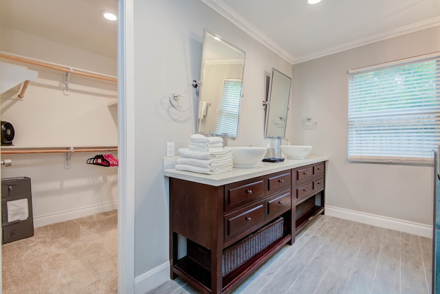 bathroom featuring ornamental molding, vanity, and hardwood / wood-style floors