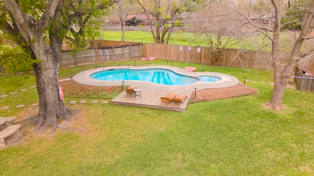 view of swimming pool featuring a yard and a deck