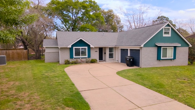 view of front facade featuring central air condition unit, a garage, and a front lawn