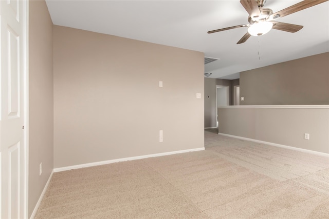 empty room featuring light carpet, baseboards, visible vents, and a ceiling fan