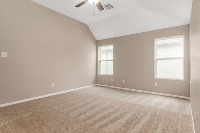 spare room with baseboards, visible vents, vaulted ceiling, and carpet flooring