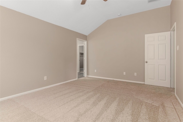 carpeted empty room featuring vaulted ceiling, a ceiling fan, and baseboards