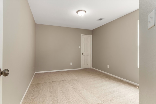 carpeted empty room with visible vents and baseboards