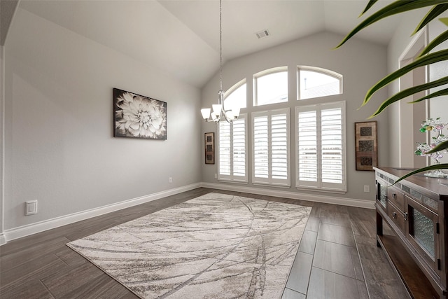 dining area with visible vents, dark wood finished floors, an inviting chandelier, baseboards, and vaulted ceiling