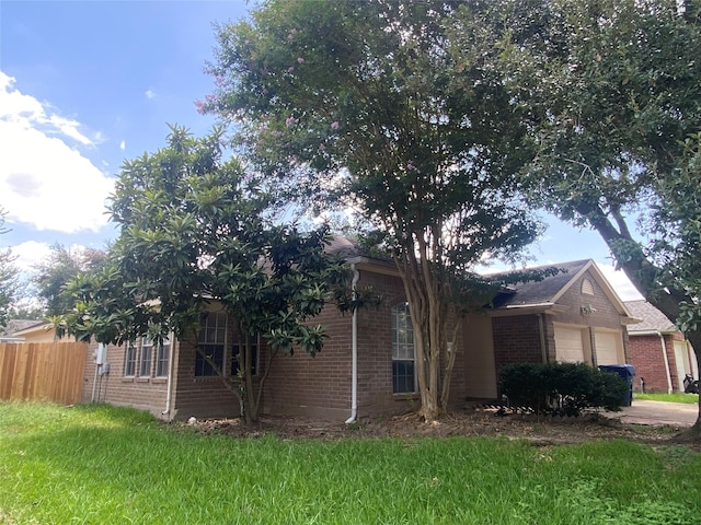 view of front of home with a front yard and a garage