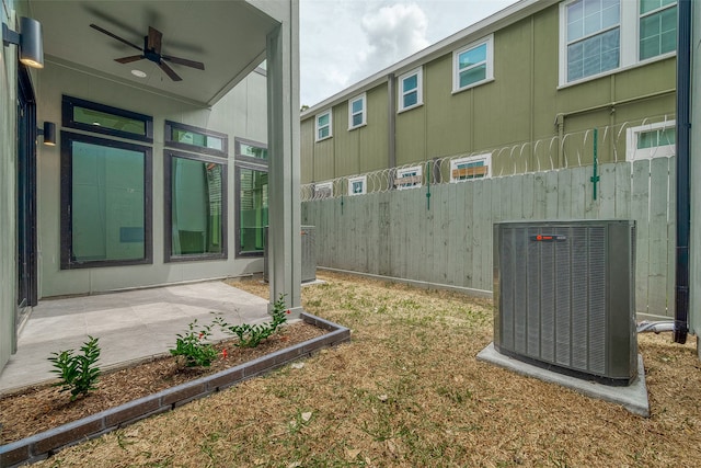 view of yard with central AC, ceiling fan, and a patio area