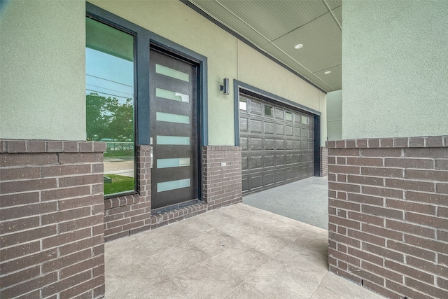 doorway to property with a garage