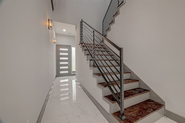 stairway featuring tile patterned floors