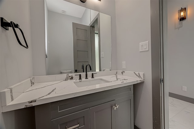 bathroom with vanity, tile patterned flooring, and toilet