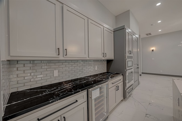 kitchen with oven, light tile patterned flooring, tasteful backsplash, and wine cooler